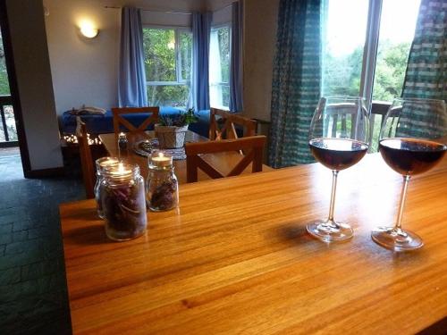 two glasses of wine sitting on a wooden table at Aguamansa in Las Gaviotas