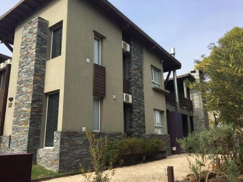 a house with a stone facade with a yard at Aguamansa in Las Gaviotas