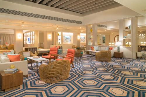 a lobby with couches and chairs and tables at The Coral at Atlantis in Nassau