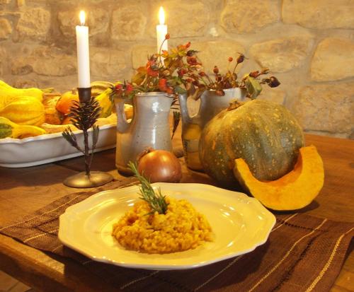 a table with a plate of food and candles at La Traversina in Stazzano