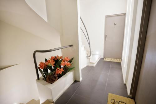 a hallway with a vase with orange flowers in it at Hotel La Villette in Antananarivo