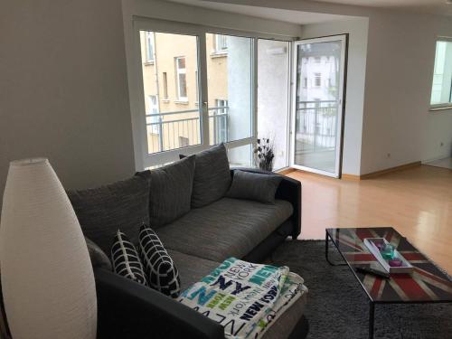 a living room with a couch and a glass table at Ferienwohnung am Clara Park in Leipzig