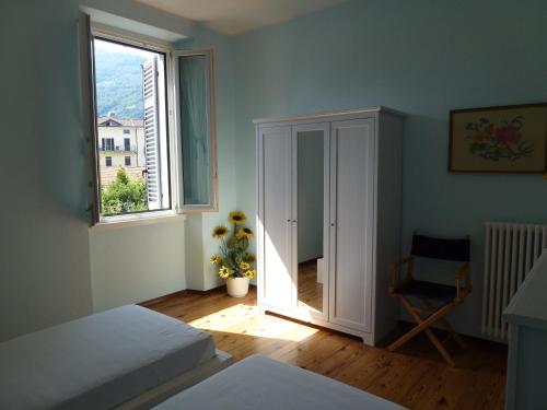 a bedroom with a bed and a window at Casa Re in Gravedona