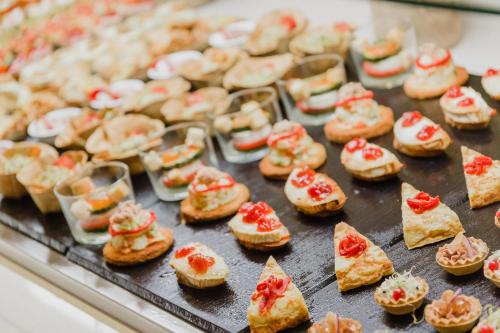 a tray filled with mini pizzas on a table at Club del Sol Aparthotel in Port de Pollensa