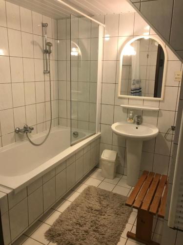 a bathroom with a sink and a tub and a shower at Appartementen De Torenhoeve in Burgh Haamstede
