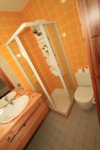 a bathroom with a shower and a sink and a toilet at Casa Branca da Vaquinha in Angra do Heroísmo