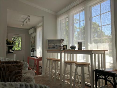 a living room with a counter and some windows at Inn At The Park - The Cottage in Cape May