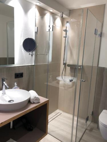 a bathroom with a sink and a shower at Landhotel Wilder Mann in Eggingen