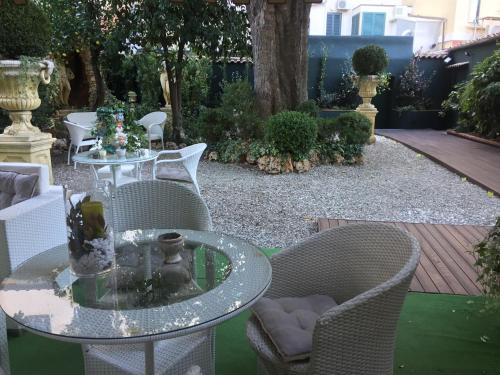 a patio with a glass table and chairs at Al Teatro in Livorno