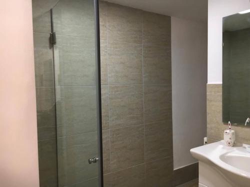 a shower with a glass door in a bathroom at Casa Oprea in Sinaia