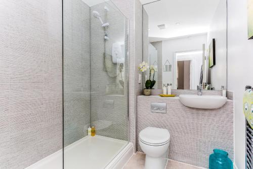 a bathroom with a shower and a toilet and a sink at 3, Gainsborough House in Cheltenham