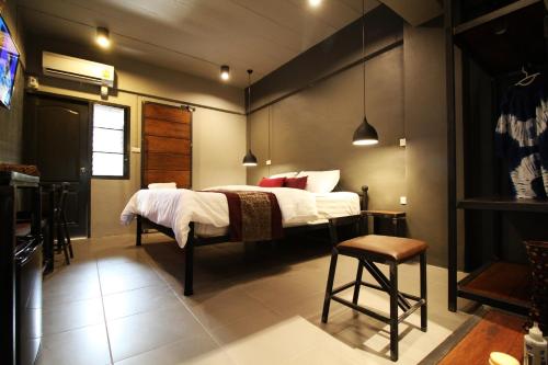 a bedroom with a bed and a table and chairs at Duangdren Place in Chiang Mai