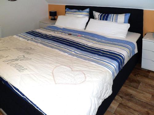 a bed with a heart drawn on it at Ferienwohnung Anke - Apartment 3a in Heinsberg