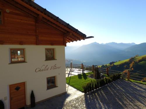 a building with a sign on the side of it at Chalet Flierer in Rodengo