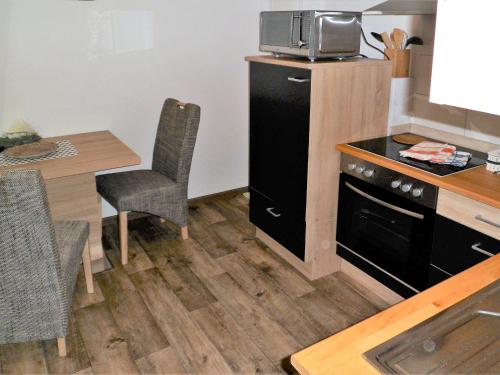 a small kitchen with a table and a microwave at Ferienwohnung Anke - Apartment 3c in Heinsberg