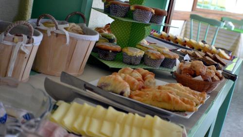 a buffet of pastries and muffins on a table at Hostería Magnolia in Villa Gesell
