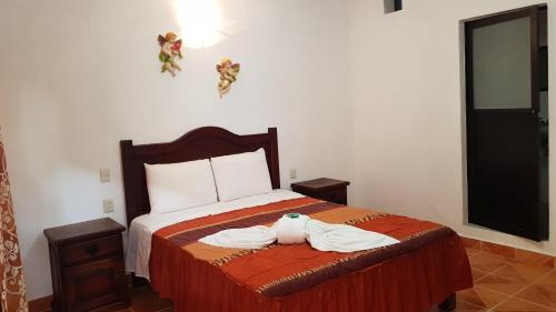 a bedroom with a bed with a stuffed animal on it at El Jardín Del Edén in Tequisquiapan