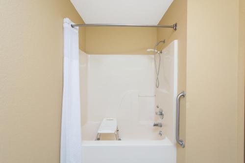 a bathroom with a shower with a toilet in it at Super 8 by Wyndham Farmington in Farmington