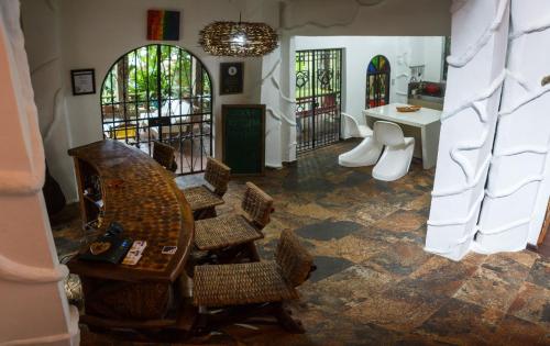 a dining room with a table and chairs in a room at The Secret Buddha in Medellín