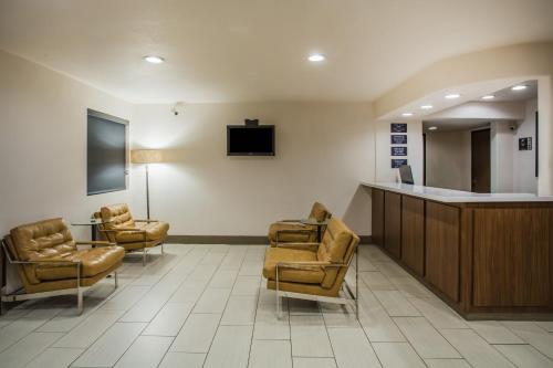 a living room filled with furniture and a tv at Super 8 by Wyndham Flagstaff in Flagstaff