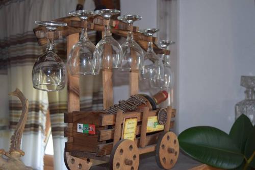 a wooden train with wine glasses on top of it at Guest Rooms Profirov in Zlatograd