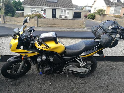a yellow motorcycle parked on the side of a street at Assaroe House in Ballyshannon