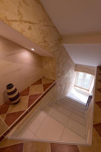 an attic with a staircase with a window at Kotor old town Palace Bucha in Kotor