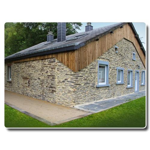 a stone building with two windows on the side of it at Chez Arsène in Bouillon