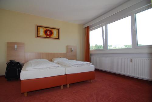 
Ein Bett oder Betten in einem Zimmer der Unterkunft Opal Hotel
