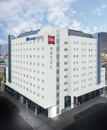 a white building with a msg hotel sign on it at ibis Iquique in Iquique