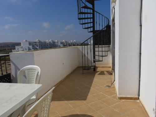 a balcony with stairs on top of a building at Chez Younès Appartement Marina Saidia Ap8 in Saidia 