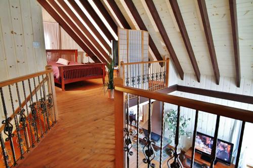 a room with a staircase and a living room with wine racks at Chalet 9017 Chemin des Alpages by Les Chalets Alpins in Stoneham