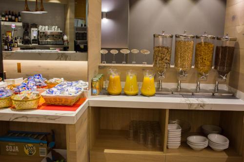 a kitchen with orange juice and other food items at Hotel Gran Via in Zaragoza