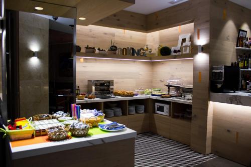 a kitchen with a table with food on it at Hotel Gran Via in Zaragoza