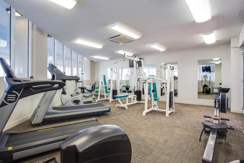 a gym with treadmills and machines in a room at Mantra Twin Towns in Tweed Heads