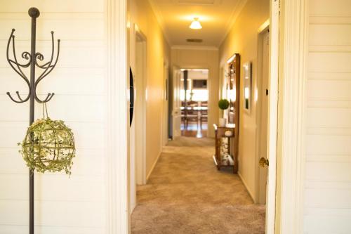 a hallway of a home with yellow walls at Bidgee Motor Inn in Hay