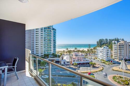 a balcony with a view of a city and the ocean at Mantra Twin Towns in Tweed Heads