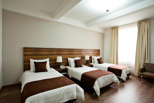 Postel nebo postele na pokoji v ubytování Hotel Nutibara