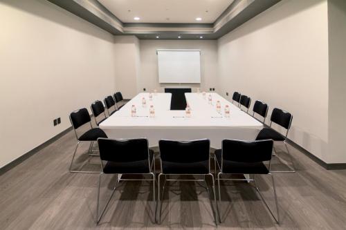 a conference room with a white table and chairs at City Express Plus by Marriott Ciudad de México Mundo E in Mexico City