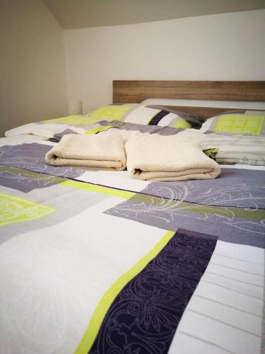 a bedroom with two beds with towels on them at Villa Gold in Nová Lesná