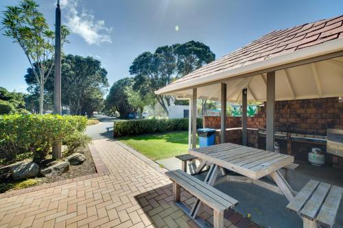 a picnic table and a pavilion in a park at Wellington TOP 10 Holiday Park in Lower Hutt