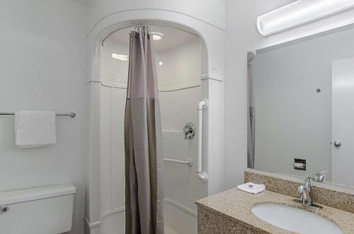 a bathroom with a shower and a sink and a toilet at Motel 6-Rock Springs, WY in Rock Springs