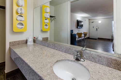 a bathroom with a sink and a large mirror at Motel 6-Staunton, VA in Staunton