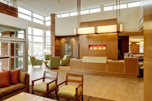a lobby of a hospital with chairs and tables at Hyatt Place New York Yonkers in Yonkers