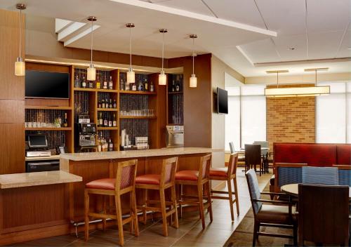 a bar in a restaurant with chairs and tables at Hyatt Place New York Yonkers in Yonkers