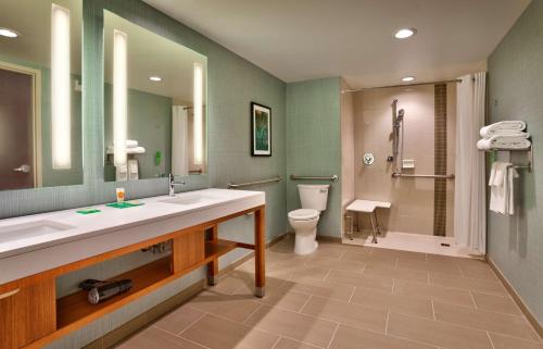 a bathroom with a sink and a toilet and a mirror at Hyatt Place Salt Lake City Farmington Station Park in Farmington