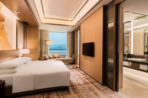 a hotel room with a bed and a bathroom at Hyatt Regency Fuzhou Cangshan in Fuzhou