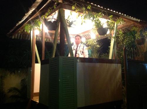 a man is standing in a gazebo at Danel Pensionne House in Tacloban