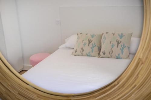 a mirror reflecting a bed in a room at Hotel La Casa in Le Barcarès