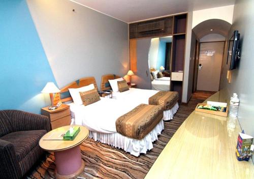 a hotel room with a bed and a couch at La Vinci Hotel in Dhaka